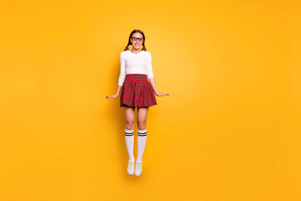 Full length body size view portrait of nice-looking attractive lovely feminine slender cheerful cheery girl wearing uniform jumping up isolated on bright vivid shine yellow background - Zdjęcie, obraz