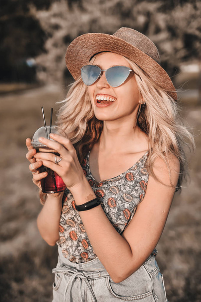 Beautiful young woman in stylish hat has a fun outdoors. - Photo, Image