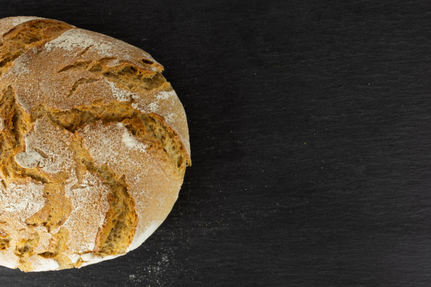 Rye wheat bread on grey stone - Фото, изображение
