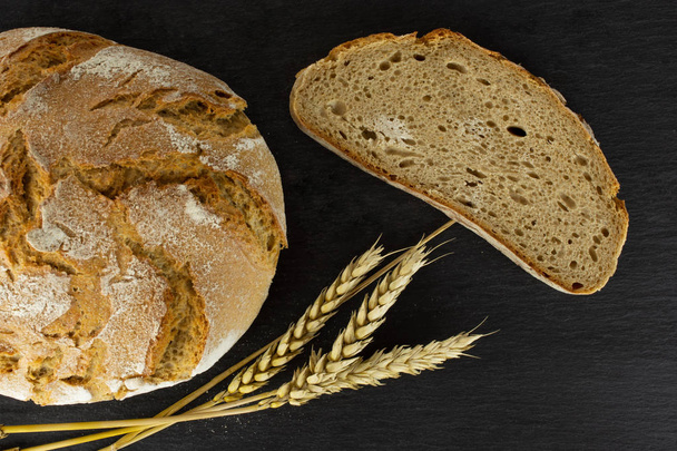 Rye wheat bread on grey stone - Фото, изображение