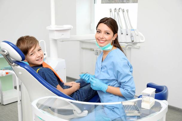 Professional dentist and little boy in clinic - Foto, immagini