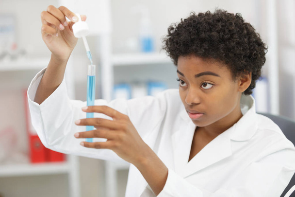 young  female scientist witha pipette in the laboratory - Fotografie, Obrázek