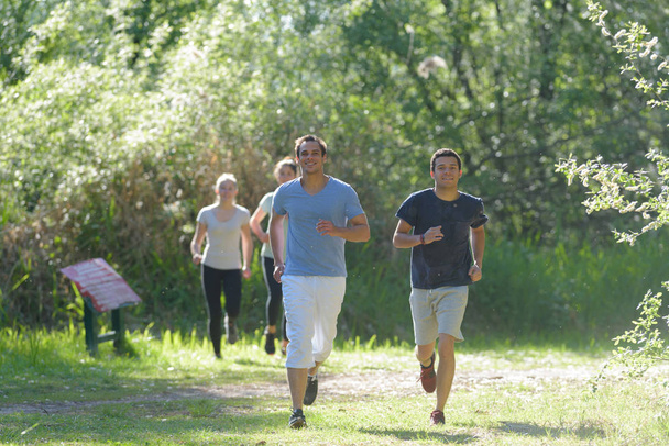 athletic people jogging in nature - Фото, зображення