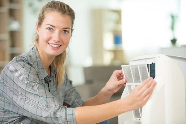 woman removing appliance filter - Foto, imagen