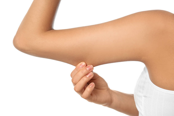 Young woman drawing attention to arm on white background, closeup. Plastic surgery concept - Foto, Imagen