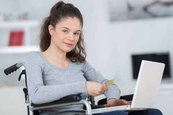 woman on wheelchair with laptop - Foto, imagen