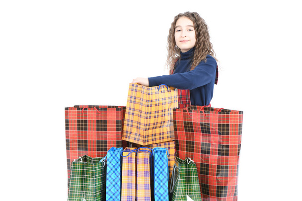 Child with a packaging checkered texture isolated on white background. Girl likes shopping on sale season. Holiday present, shopping.  - Foto, Bild