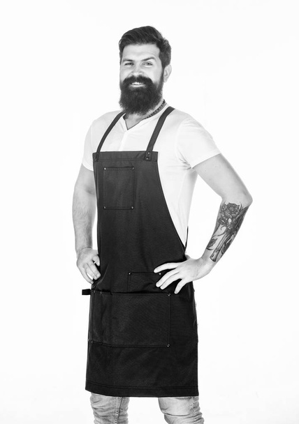 Apron for true guy at the grill. Master of grill in cooking apron with pockets. Bearded man in kitchen apron. Stylish grill cook keeping hands on hips. Cook with long beard wearing bib apron - Foto, immagini