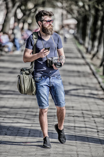Content creator. Man bearded hipster photographer. Old but still good. Photographer hold vintage camera. Modern blogger. Manual settings. Photographer with beard and mustache. Tourist shooting photos - 写真・画像