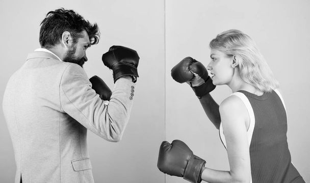 Man formal suit and athletic woman boxing fight. Couple in love competing in boxing. Female and male boxers fighting in gloves. Domination concept. Gender battle. Gender equal rights. Gender equality - Fotografie, Obrázek