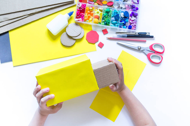 School bus made of cardboard. DIY children's pencil case for stationery paper craft. - 写真・画像