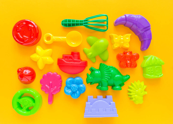 Toys for sand. Children's toy summer sea game. Copy space banner. Flat lay. Rainbow color. - 写真・画像