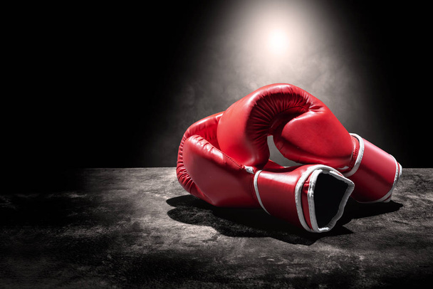 Pair of red boxing gloves under the light - Foto, Imagen