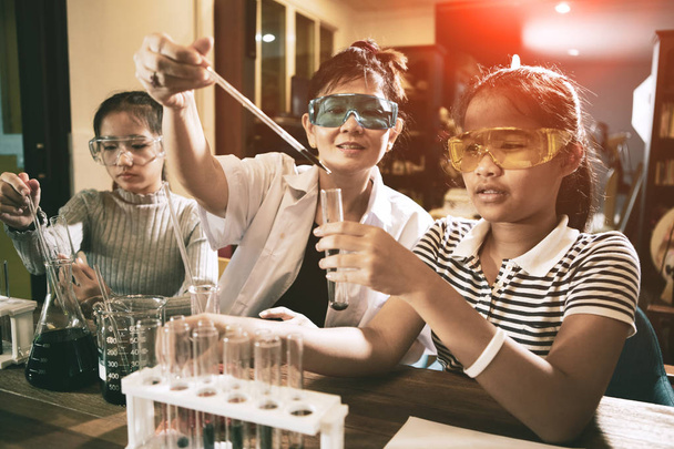 asian teacher and student in school science laboratory room - Photo, Image