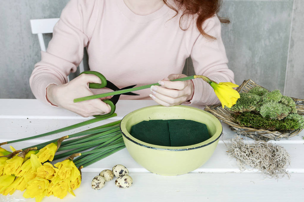 How to make Easter table decoration with daffodils and moss in c - Foto, imagen