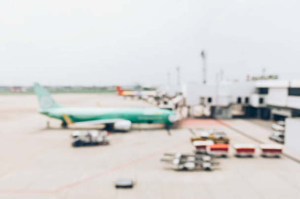 Blurred image of airplane waiting for passenger to boarding in a - 写真・画像