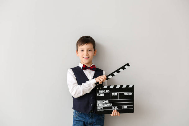 Little boy with clapperboard on white background - Photo, image