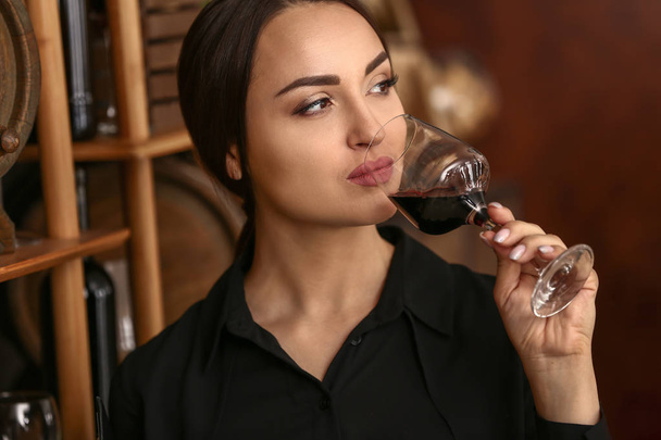 Female sommelier working in wine cellar - Photo, Image