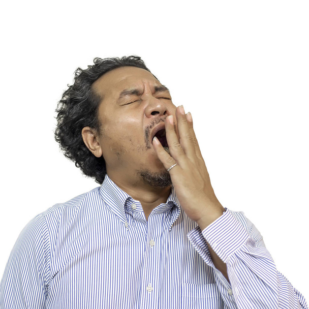 Tired business man yawning isolated on a white background. - Photo, Image