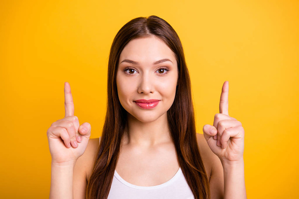 Close up photo beautiful funny she her lady ideal perfect appearance hands arms index fingers indicate up empty space advising buy buyer wear casual white tank-top isolated bright yellow background - Photo, image