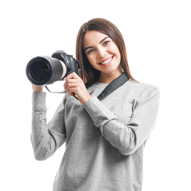 Young female photographer on white background - Φωτογραφία, εικόνα