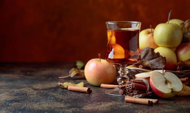 Glass of apple juice or cider with juicy apples and cinnamon sti - Photo, Image