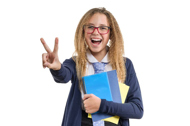 Isolated portrait of schoolgirl showing victory sign - Photo, image