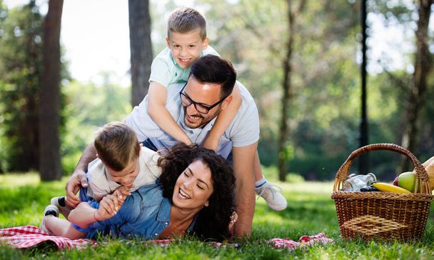 Happy family enjoying picnic with kids in nature - Fotografie, Obrázek
