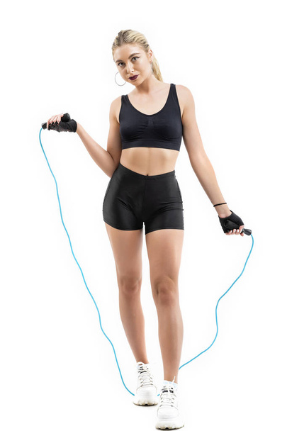 Beautiful sportsgirl with skipping rope isolated on white - Photo, image