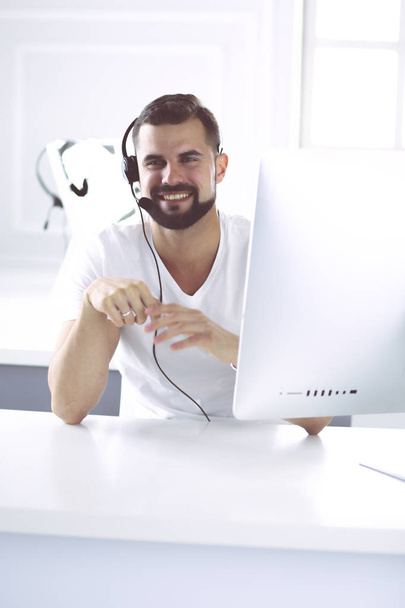 Businessman in the office on the phone with headset, Skype - Фото, изображение