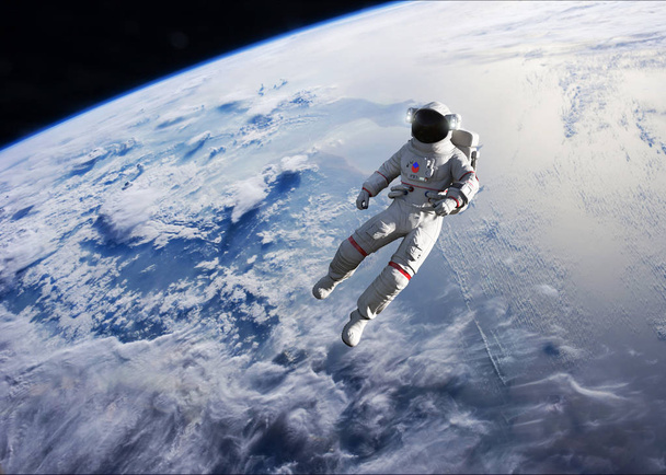 地球軌道上で宇宙遊歩を行う宇宙飛行士 - 写真・画像