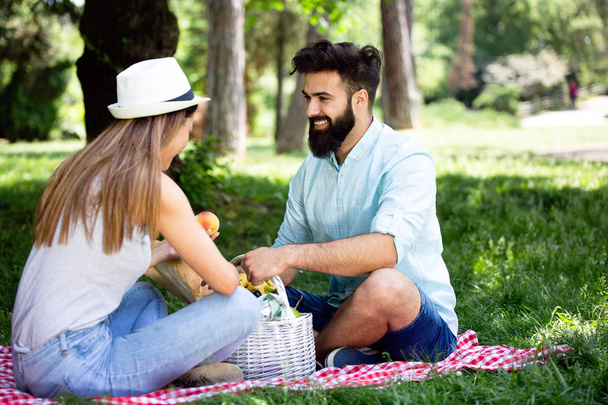 Happy young couple enjoying a day in the park together - Fotografie, Obrázek