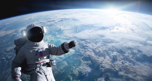 地球軌道上で宇宙遊歩を行う宇宙飛行士 - 写真・画像