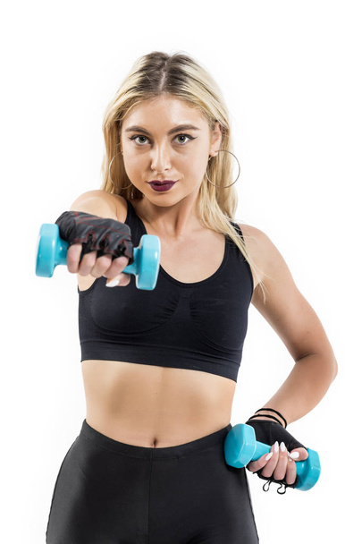 Beautiful fit woman exercising with dumbbells - Foto, Bild