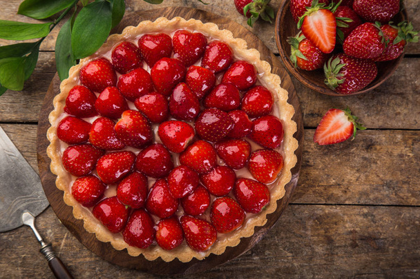 delicious strawberry tart on wooden background - Fotoğraf, Görsel