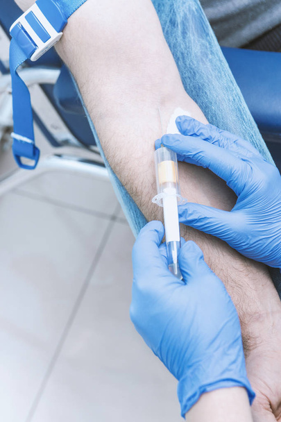 Nurse taking a blood sample, close up - Photo, Image
