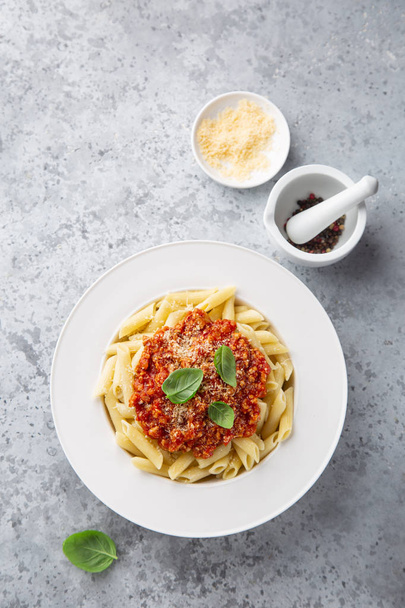 penne pasta with Bolognese sause in white plate - Photo, image