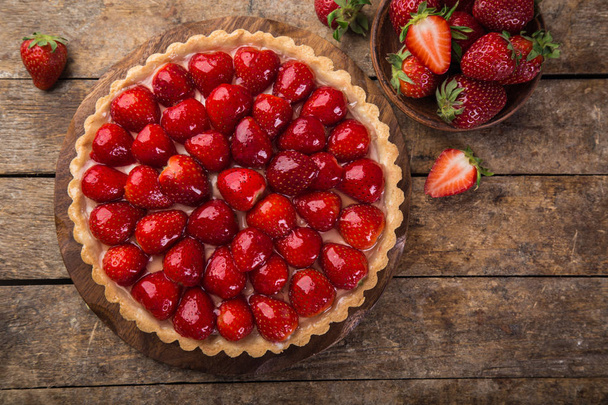 delicious strawberry tart on wooden background - Photo, Image