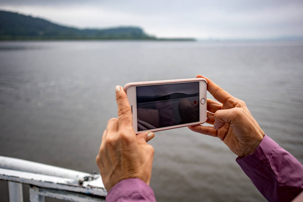 Жінка руки тримає телефон зйомки відео озера
 - Фото, зображення