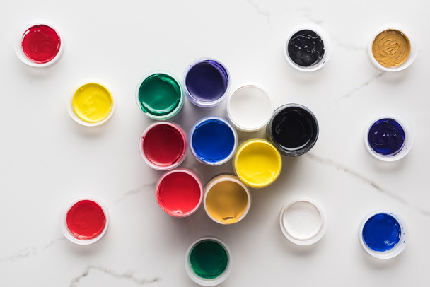 top view of multicolored gouache paints on marble white surface - Valokuva, kuva