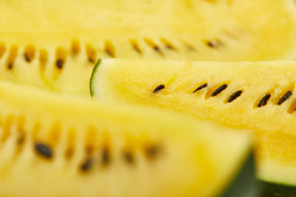close up view of ripe yellow tasty watermelon with seeds - Photo, image