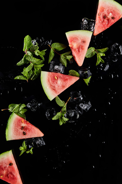top view of red watermelon slices with mint and ice isolated on black - Zdjęcie, obraz