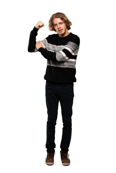Full-length shot of Blonde man doing strong gesture over isolated white background - Foto, Imagen