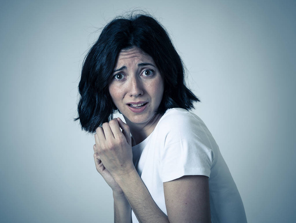 Close up of young woman with frightened eyes, shocked, cowered, cringing. Looking terrified and desperate. People and Human expressions and emotions concept. Isolated on neutral background. - Photo, Image