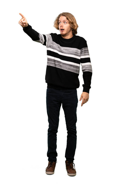 Full-length shot of Blonde man pointing away over isolated white background - Photo, Image