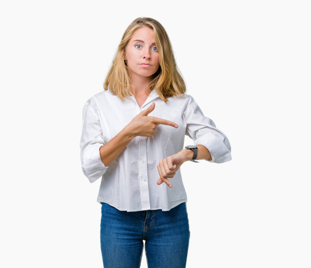 Beautiful young business woman over isolated background In hurry pointing to watch time, impatience, upset and angry for deadline delay - Photo, Image
