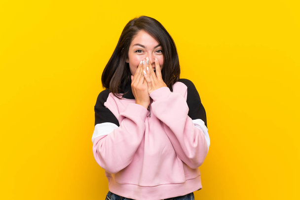 Young Mexican woman over isolated yellow background with surprise facial expression - Foto, imagen