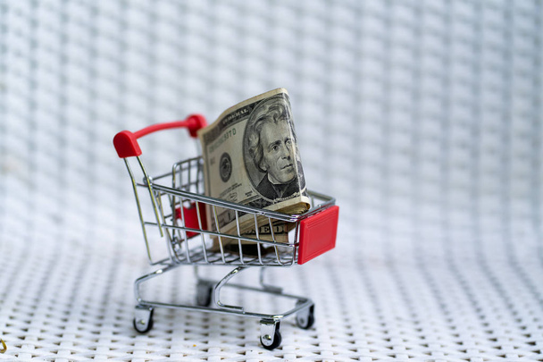Shopping cart with dollar banknote USD - Фото, зображення