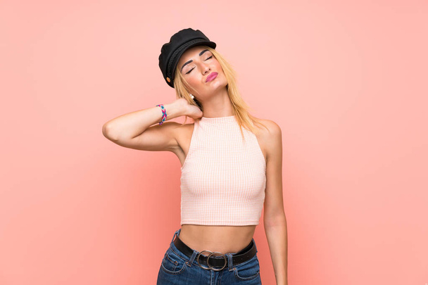 Young blonde woman with hat with neckache - Photo, Image