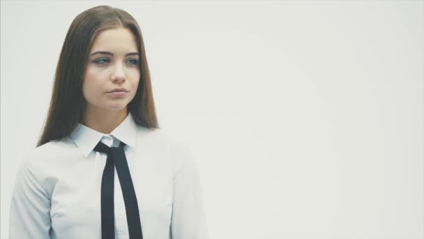 Confident in a young business woman. Wearing a white shirt carefully looks to the side. Isolated on a white background. Sincerely smiles. Has beautiful blue eyes. - Filmagem, Vídeo